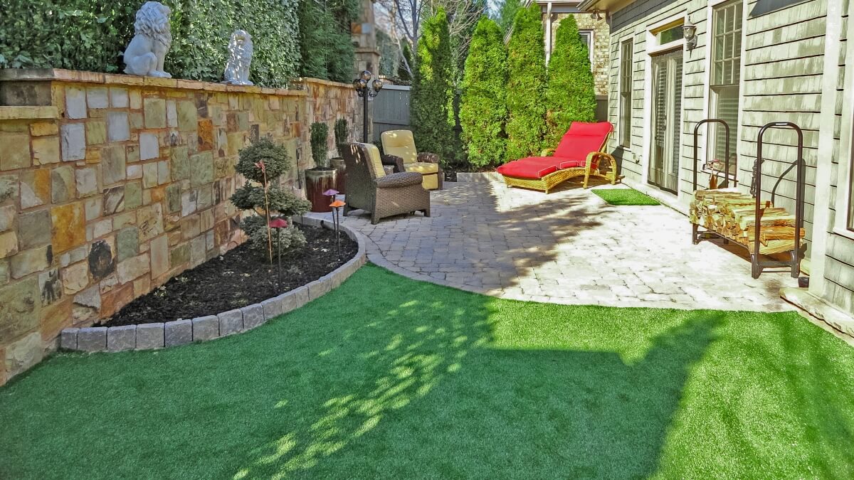 small backyard living space with synthetic turf