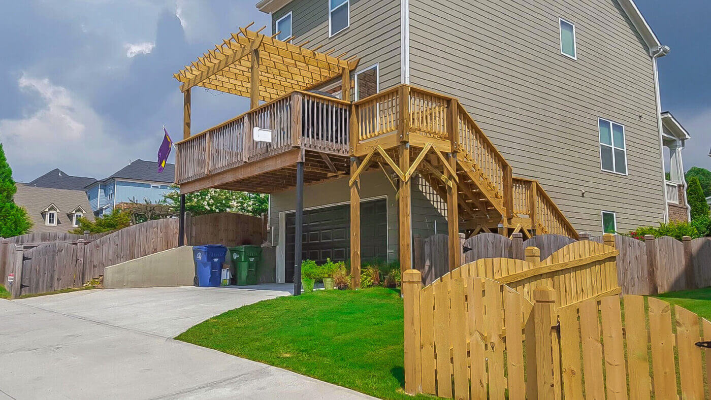 wood deck with pergola over backyard home garage