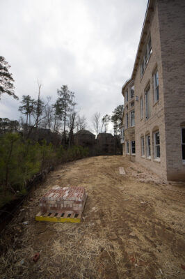 backyard landscape construction for erosion prevention of new brick house